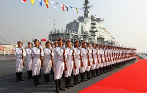 Naval honour guards stand as they wait for a review on China's aircraft carrier 